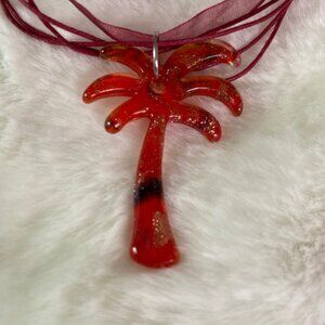 Red ribbon with palm tree pendant set